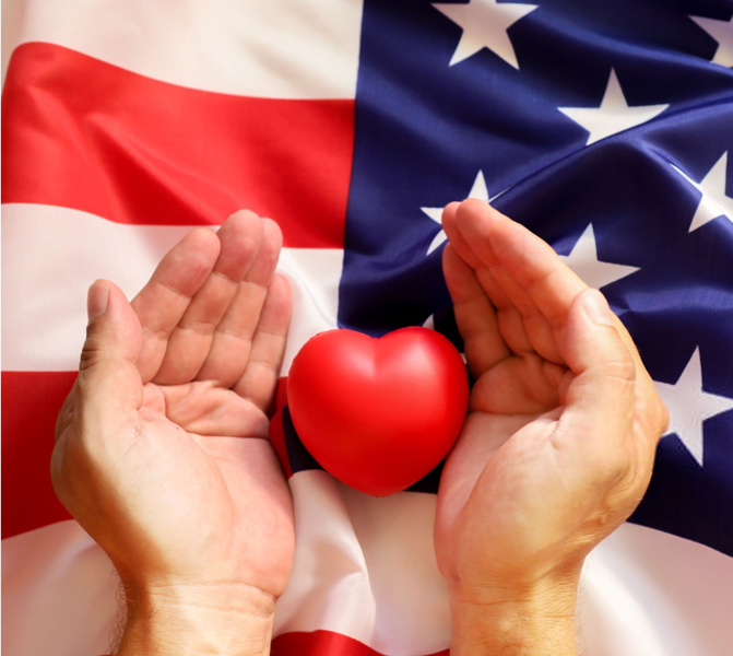 hands around a heart figure on top of american flag