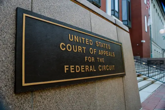 Bronze plaque on a stone wall reading United States Court of Appeals for the Federal Circuit.